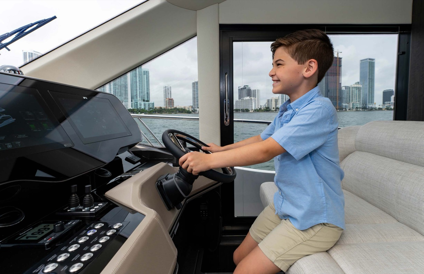 Young skipper at the helm with dual navigation displays