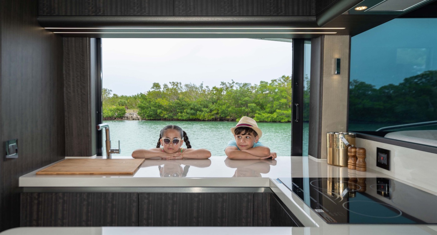 Two children at the galley island, mangrove cove beyond the window