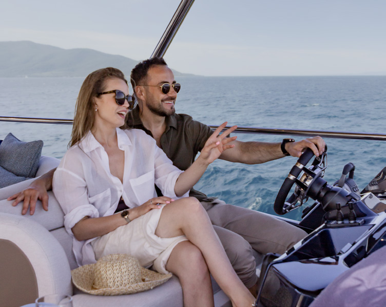 620 FLY flybridge helm with a man at the wheel
