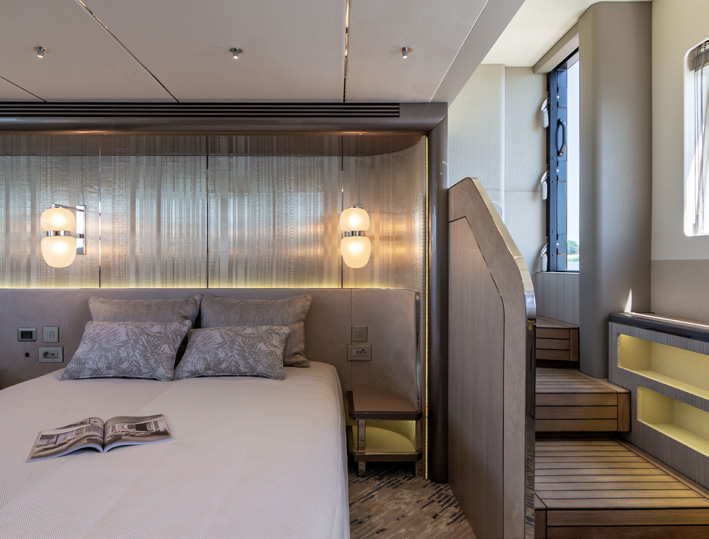 620 FLY guest cabin with double bed and wooden steps up