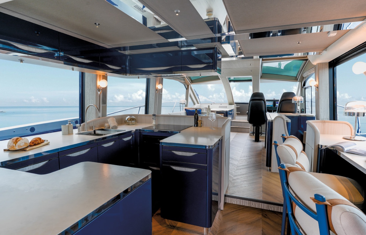 Main-deck galley and salon with sea views through open side windows