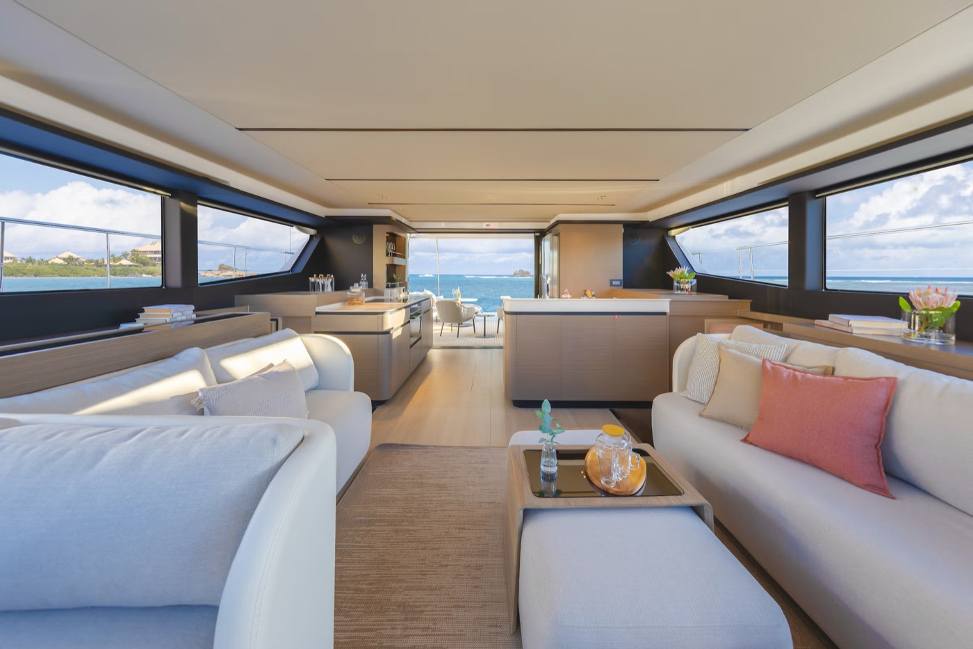 The 53PC saloon: white sofas, island galley and panoramic sea views