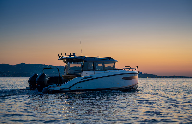 Navan C30 cruising at dusk with twin outboards