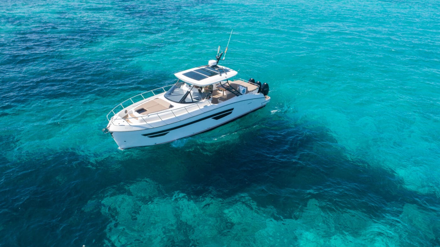 Stern-quarter view of the Oryx 379 cruising with guests aboard