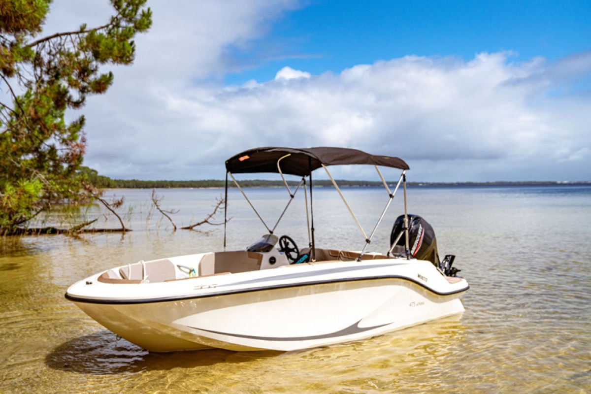 Quicksilver 475 aXess anchored near shore
